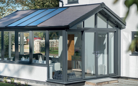 Modern anthracite grey conservatory with a solid roof